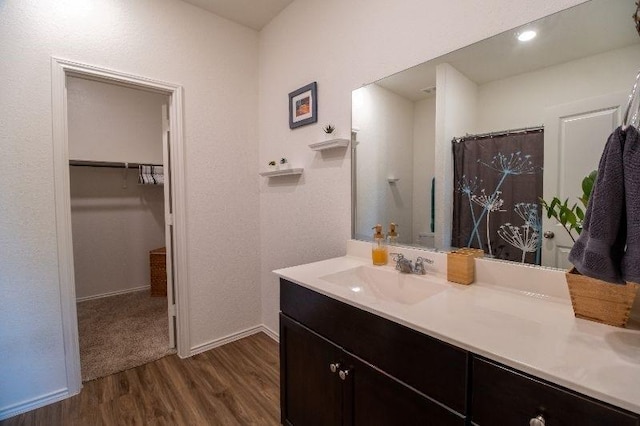 bathroom with vanity, hardwood / wood-style floors, and walk in shower