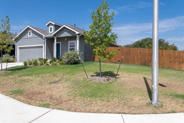 view of front of property with a garage and a front yard