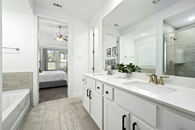 bathroom featuring double vanity, visible vents, ensuite bathroom, a stall shower, and a sink