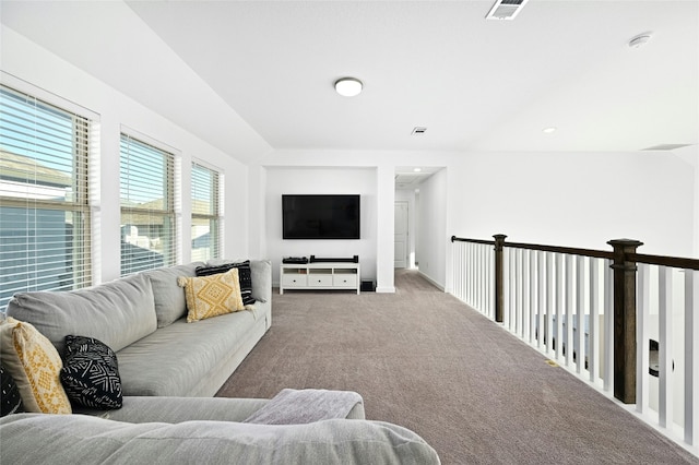 carpeted living area featuring baseboards, visible vents, and recessed lighting