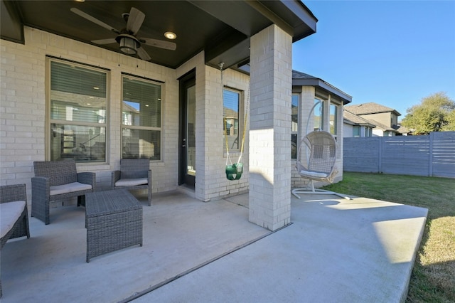 view of patio featuring fence and a ceiling fan