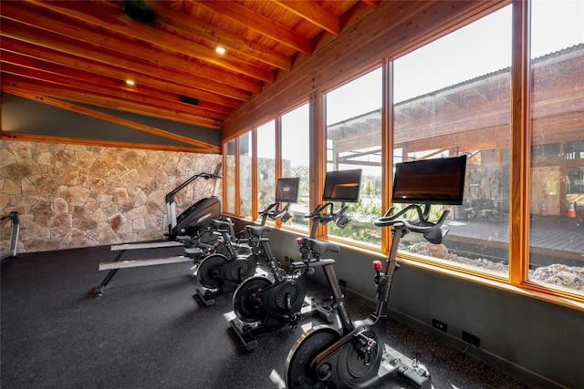 exercise room featuring wooden ceiling and vaulted ceiling