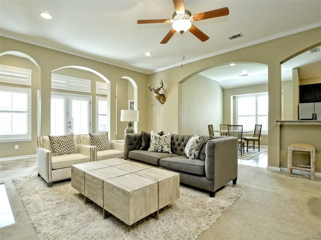 5021 Pyrenees Pass, Austin, TX 78738 - living area featuring arched walkways, crown molding, baseboards, a ceiling fan, and recessed lighting