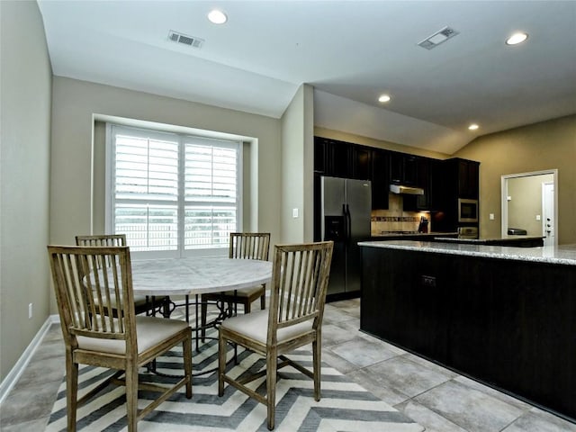 5021 Pyrenees Pass, Austin, TX 78738 - kitchen with appliances with stainless steel finishes, recessed lighting, vaulted ceiling, dark cabinets, and light stone countertops