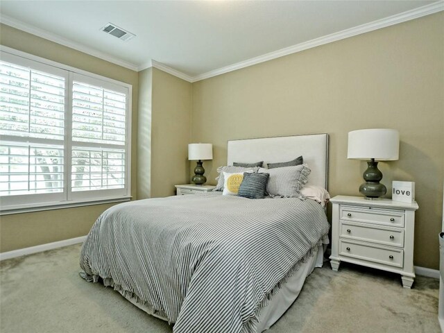 bedroom with multiple windows, light colored carpet, and ornamental molding