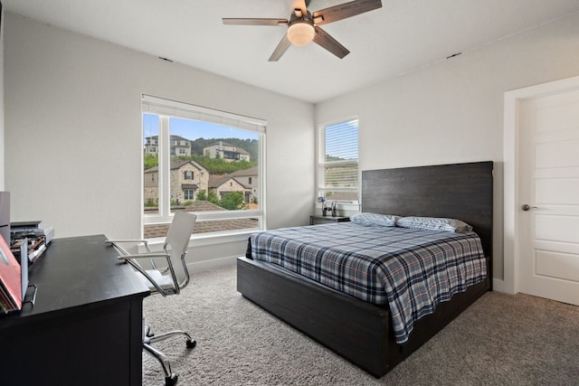 bedroom featuring ceiling fan and carpet