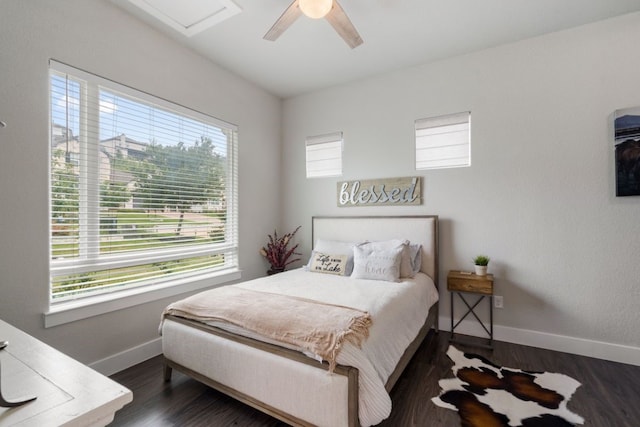 bedroom with dark hardwood / wood-style flooring and ceiling fan