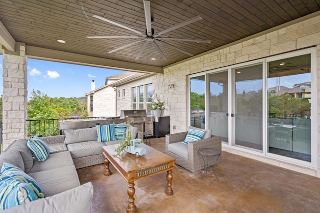 view of patio with area for grilling, an outdoor living space, an outdoor kitchen, and ceiling fan