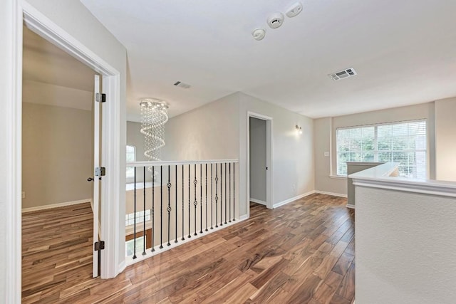 interior space featuring hardwood / wood-style flooring and a notable chandelier