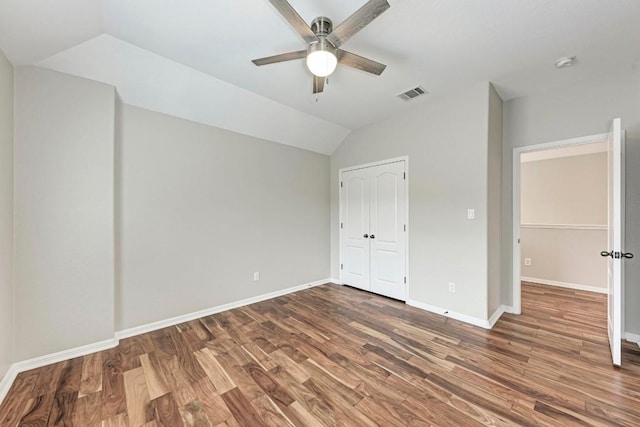 unfurnished bedroom featuring dark hardwood / wood-style floors, ceiling fan, and lofted ceiling