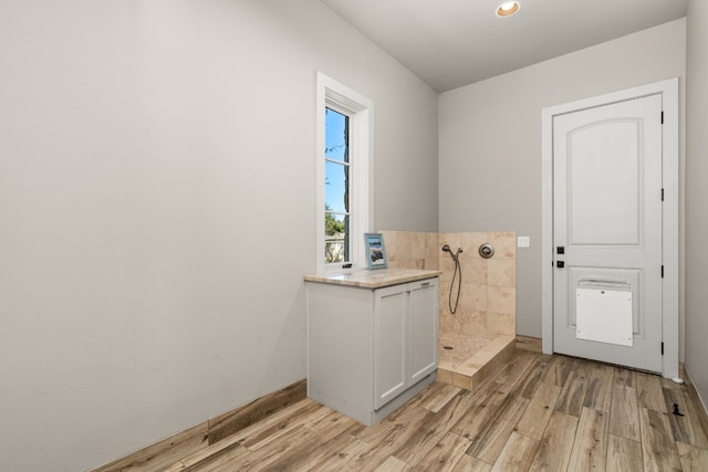 bathroom with hardwood / wood-style floors