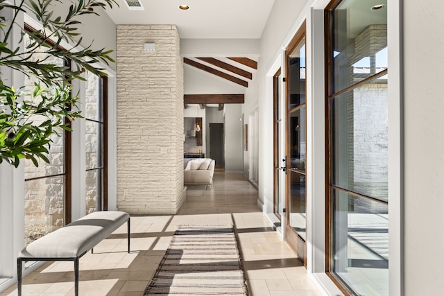 hall featuring lofted ceiling with beams