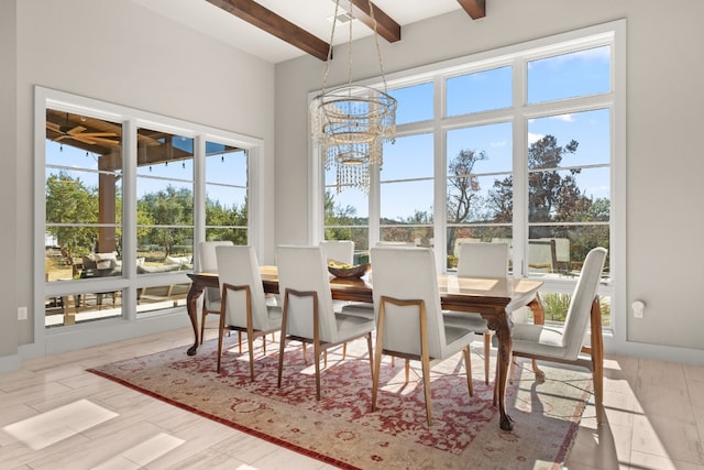 dining area featuring beam ceiling, plenty of natural light, and a notable chandelier