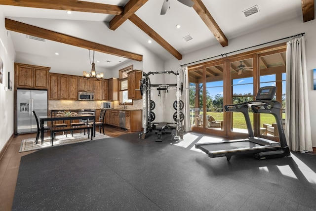 workout area with ceiling fan with notable chandelier and high vaulted ceiling