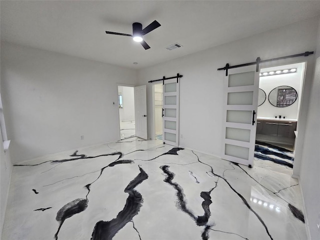 bedroom with a ceiling fan, visible vents, concrete floors, and a barn door