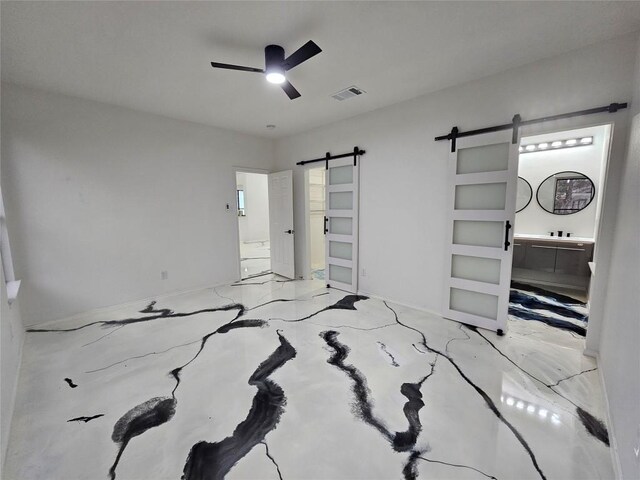 11806 Prairie Hen Ln, Austin, TX 78758 - unfurnished bedroom with a barn door and a ceiling fan
