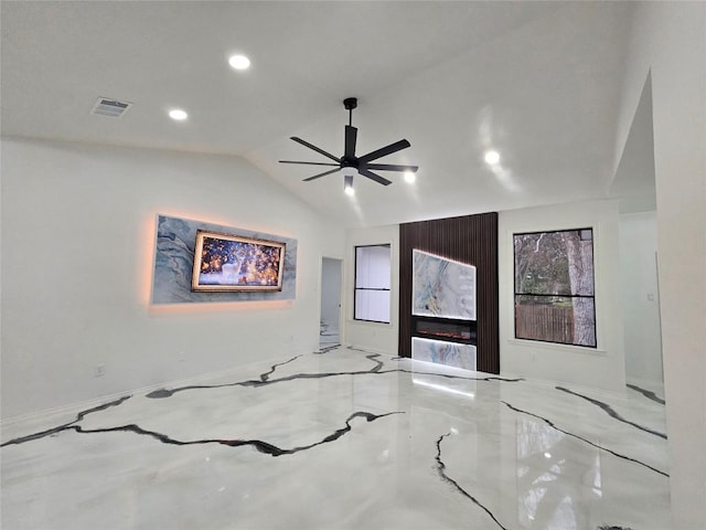 spare room featuring ceiling fan, a fireplace, and vaulted ceiling