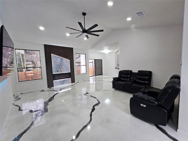 living room featuring ceiling fan and lofted ceiling