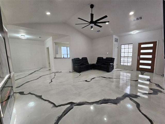 living area with ceiling fan and vaulted ceiling