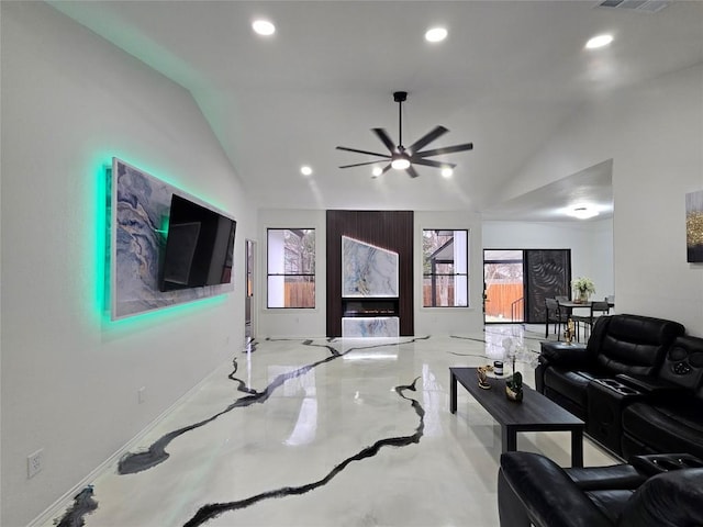 living area with a healthy amount of sunlight, vaulted ceiling, and recessed lighting