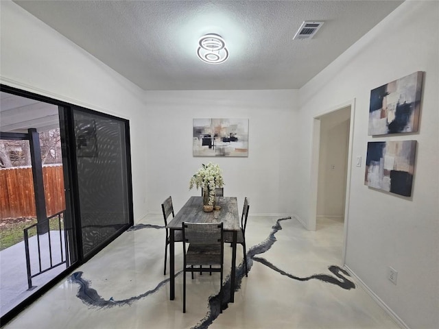 11806 Prairie Hen Ln, Austin, TX 78758 - dining area featuring concrete flooring and a textured ceiling
