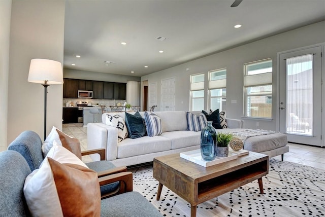 living room with ceiling fan and light tile patterned floors