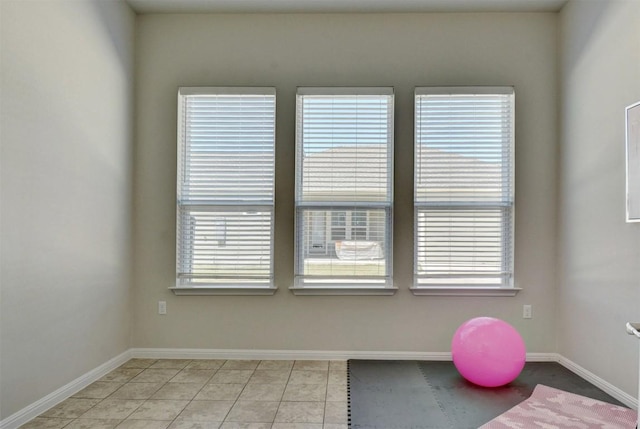 workout area featuring light tile patterned floors