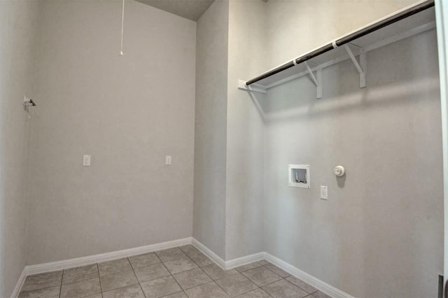 washroom featuring washer hookup, hookup for a gas dryer, and light tile patterned flooring