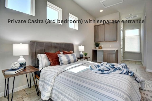 tiled bedroom featuring lofted ceiling