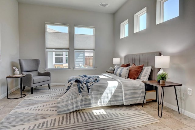 bedroom featuring multiple windows and light tile patterned flooring