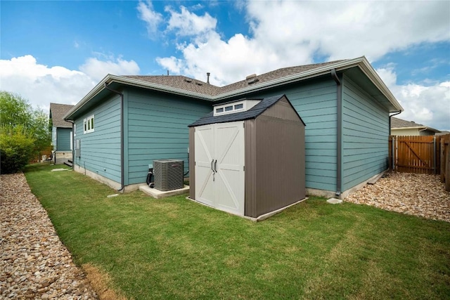 view of outdoor structure featuring cooling unit and a yard