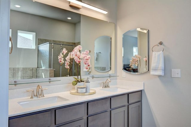 bathroom with vanity and a shower with door