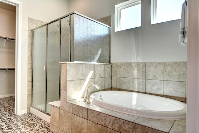 bathroom featuring tile patterned flooring and shower with separate bathtub