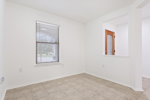 unfurnished room featuring light tile patterned flooring