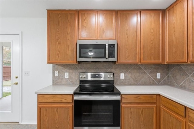 kitchen featuring appliances with stainless steel finishes and tasteful backsplash