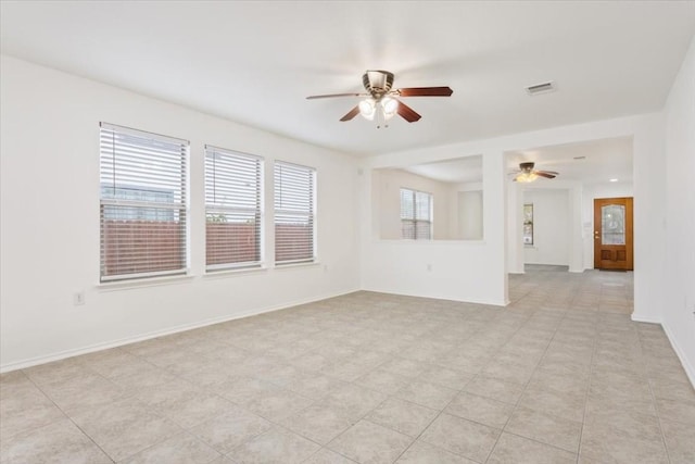 tiled empty room with ceiling fan