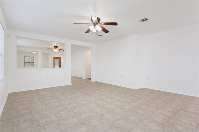 spare room featuring ceiling fan and light tile patterned floors