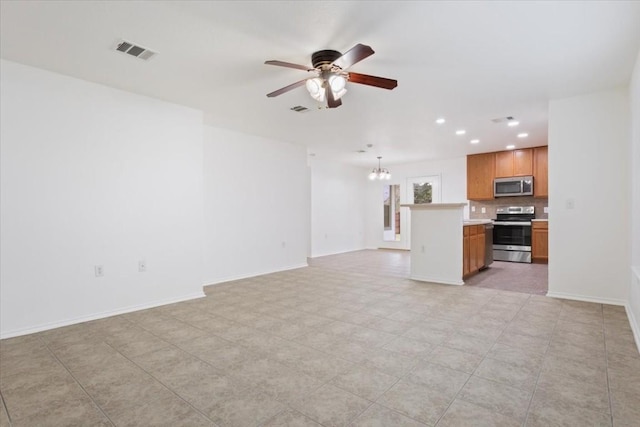 unfurnished living room with ceiling fan with notable chandelier and light tile patterned flooring