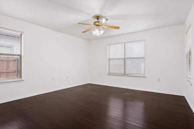 unfurnished room with ceiling fan and dark wood-type flooring