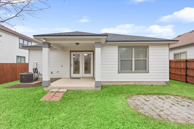 rear view of property with central AC, a yard, and a patio