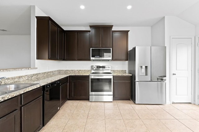 kitchen featuring dark brown cabinetry, light stone countertops, sink, light tile patterned floors, and appliances with stainless steel finishes