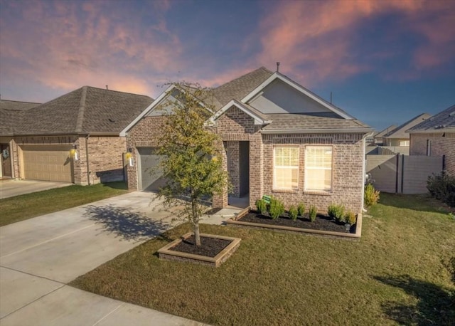 view of front of property with a garage and a lawn