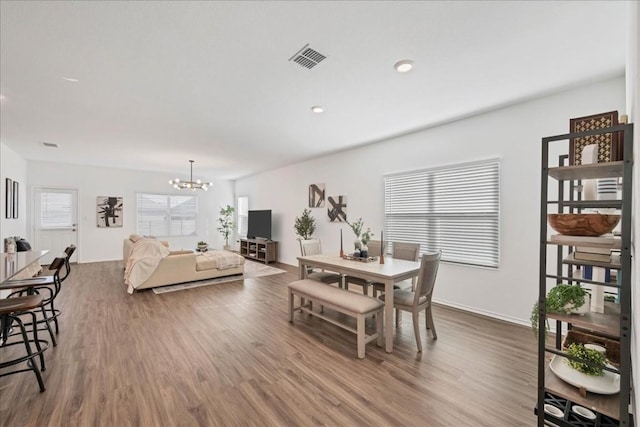 dining room featuring a wealth of natural light, visible vents, and wood finished floors