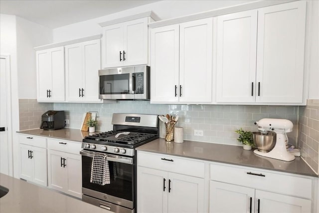 kitchen featuring white cabinetry, appliances with stainless steel finishes, and tasteful backsplash