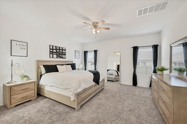 bedroom with ceiling fan and light colored carpet