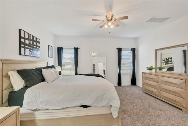 bedroom with ceiling fan and light colored carpet