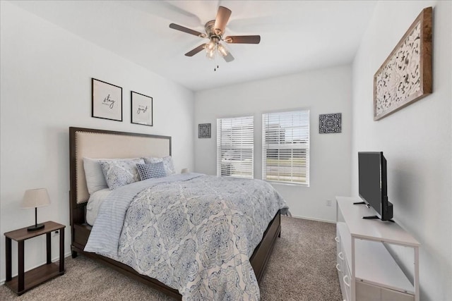 bedroom with ceiling fan, carpet flooring, and baseboards