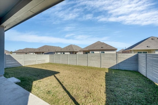 view of yard with a fenced backyard