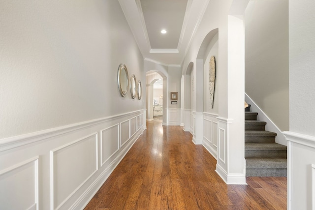 corridor with dark hardwood / wood-style floors and ornamental molding