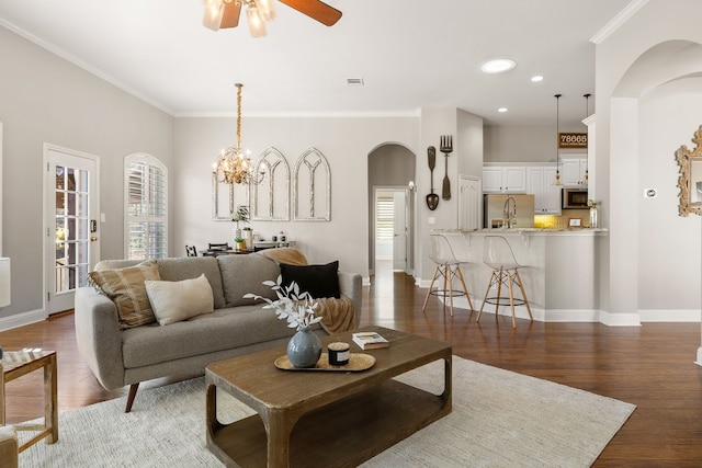 living room with ornamental molding, dark hardwood / wood-style flooring, and a healthy amount of sunlight